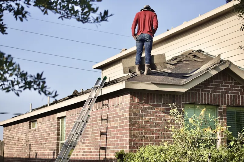 Professional roofer working on a residential roof in Gary